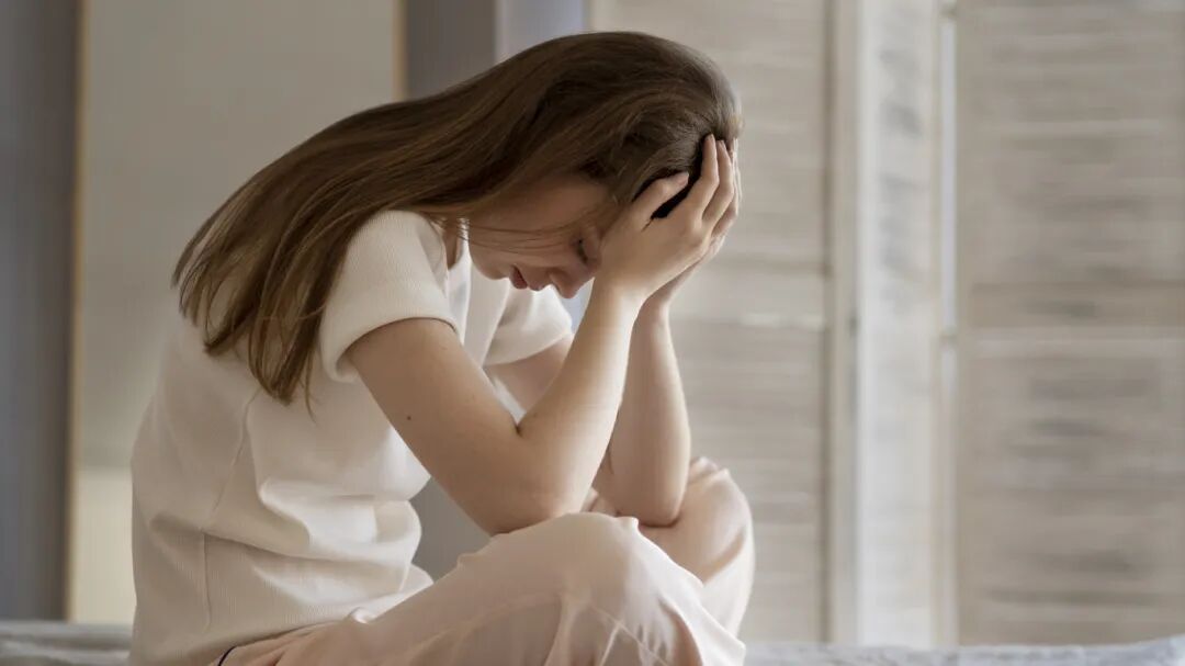 anxious-woman-sitting-bed-full-shot (1).jpg