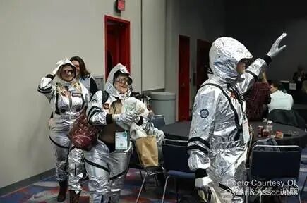 A group of people wearing silver suits

AI-generated content may be incorrect.