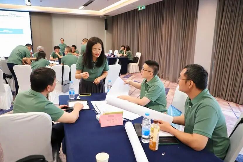 一群人坐在桌子前 中度可信度描述已自动生成